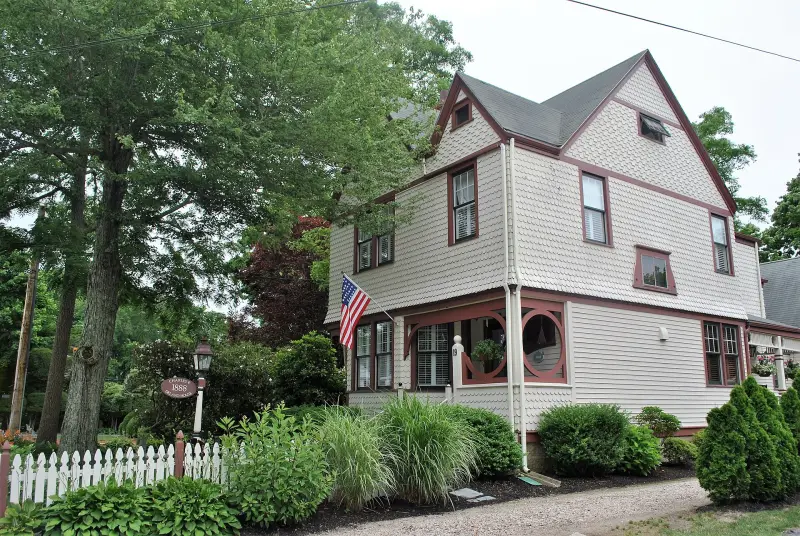 Shingled Victorian house with an American flag in Falmouth